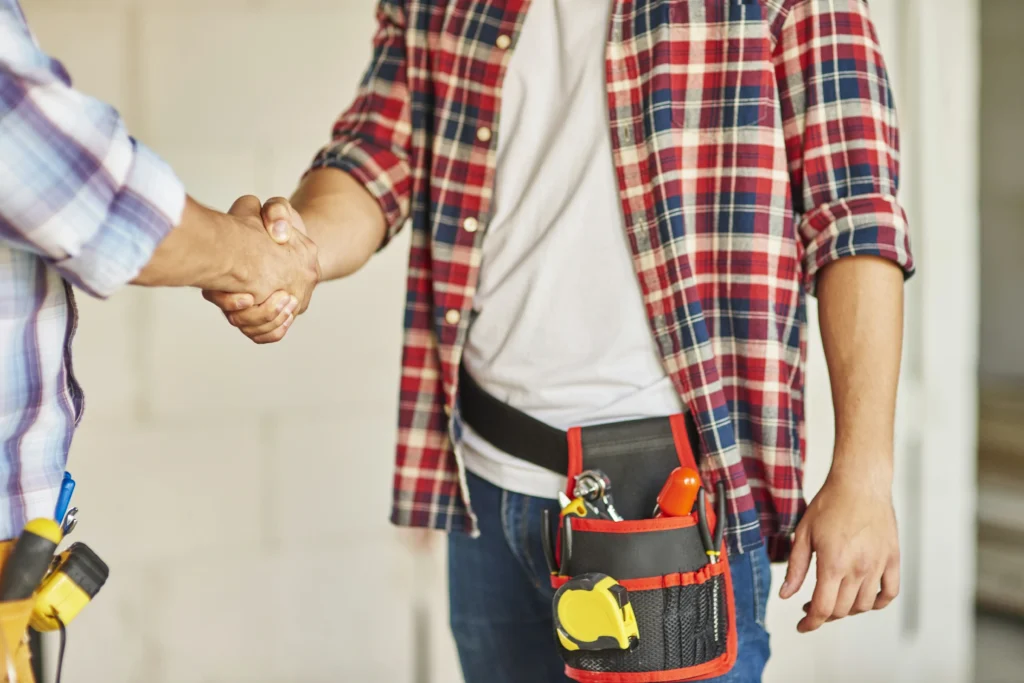 close up workers cooperating shaking hands