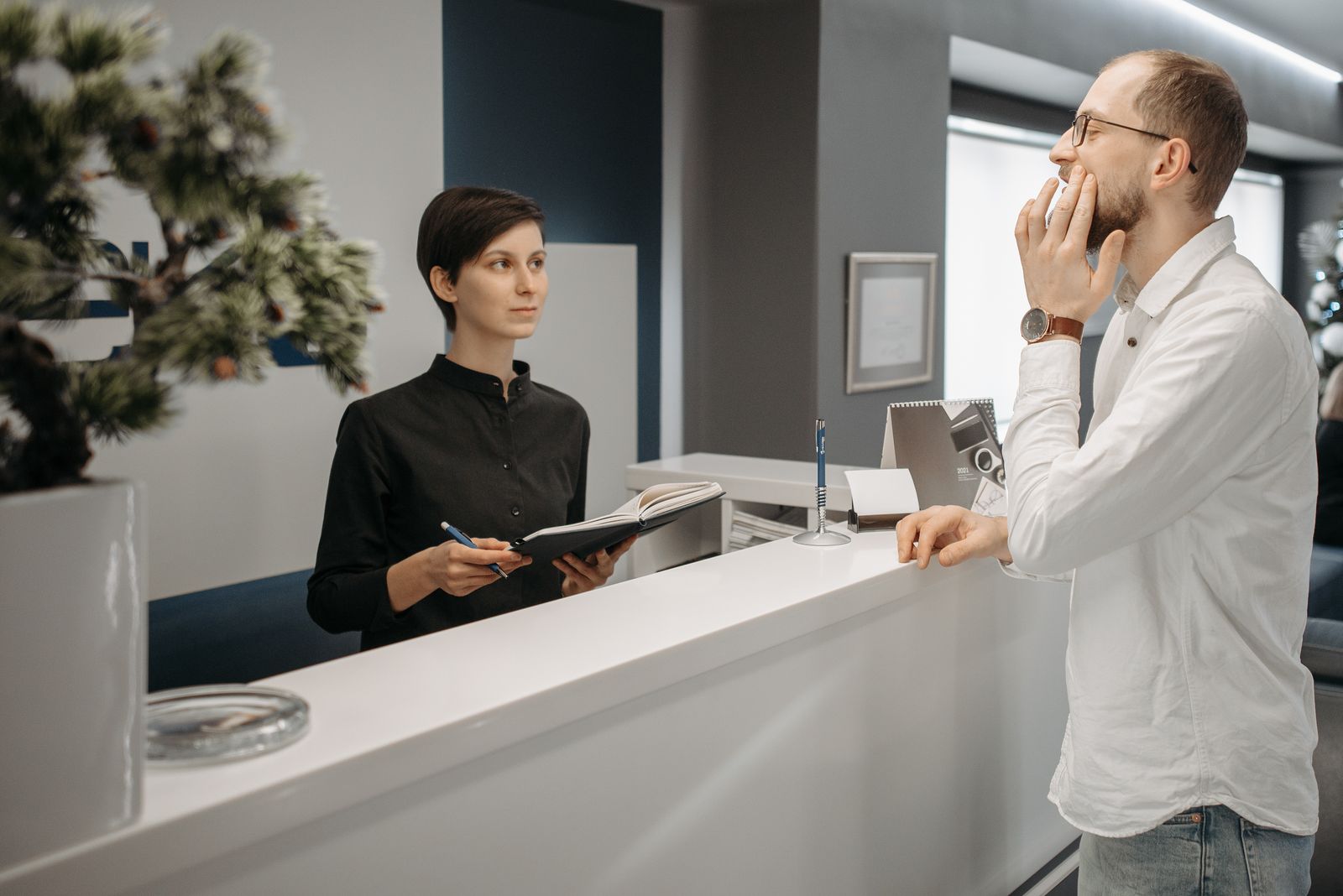 Patient scheduling a dental appointment at the front desk, where Local Services Ads for dentists deliver every lead as a phone call