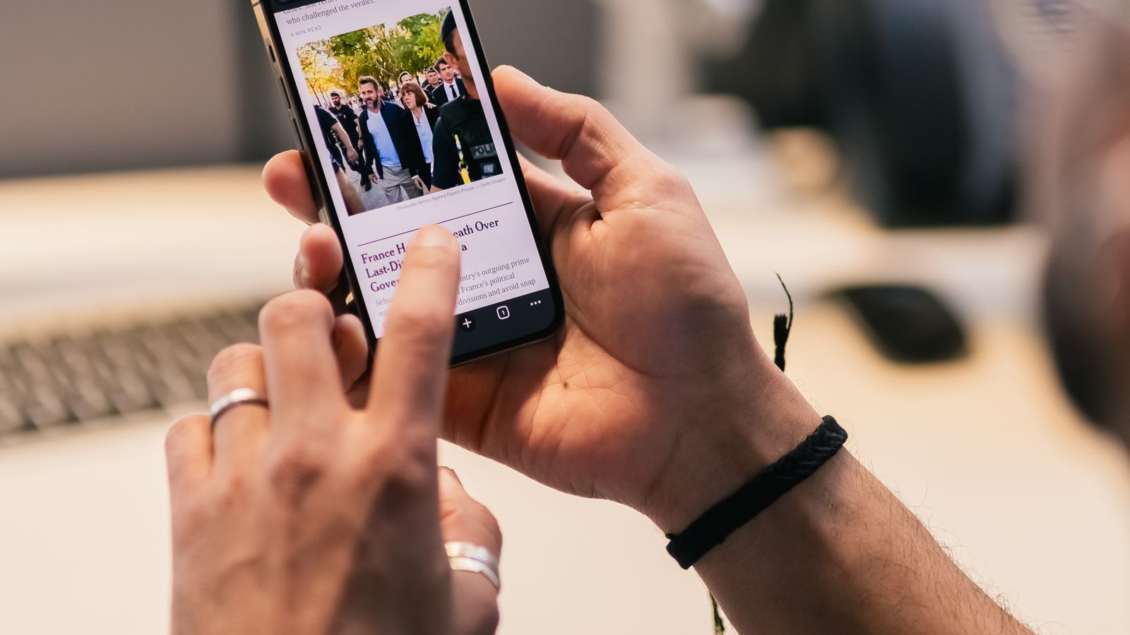 Practice staff member texting a patient on a smartphone in a dental or medical office, illustrating TCPA compliance for dental and medical practices